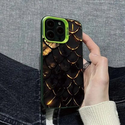 Phone case with dragon scale design held by a person against a gray background