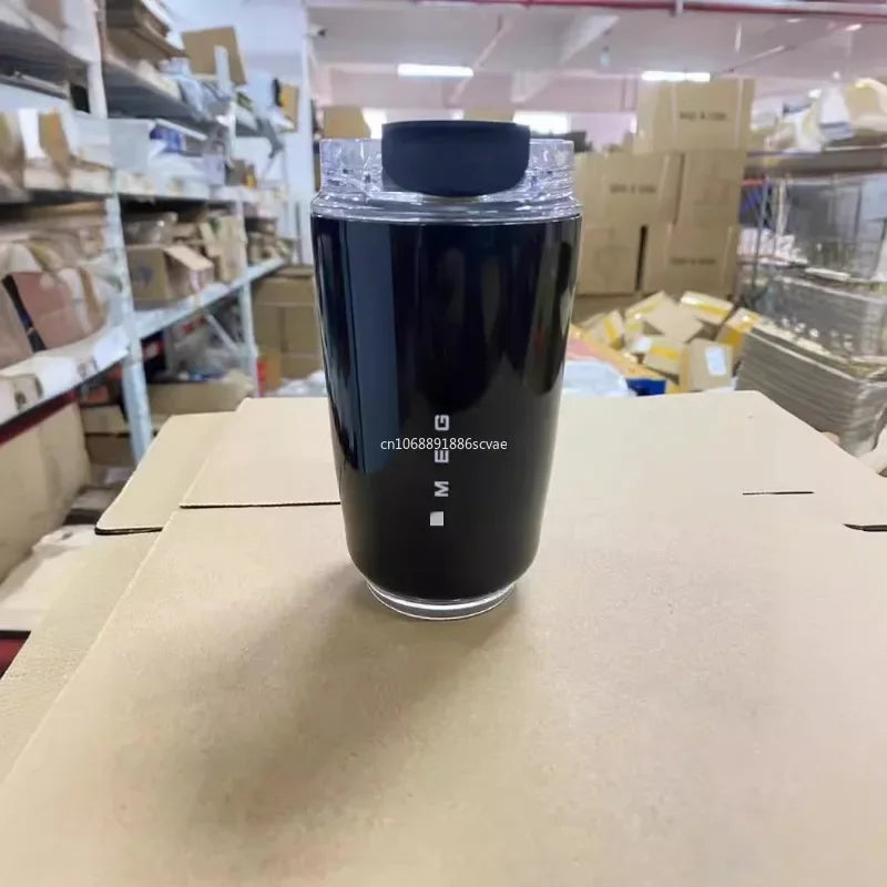 SMEG Black cylindrical container with a logo on a cardboard surface in a warehouse setting