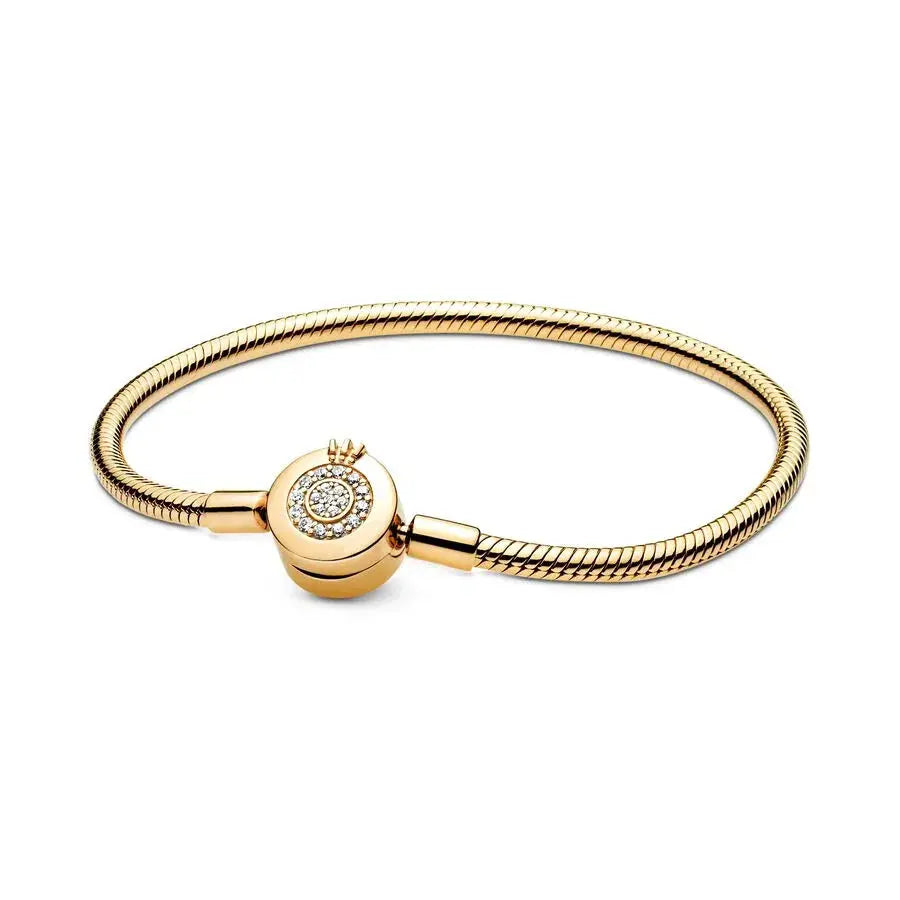 Gold bracelet with a round clasp on a white background