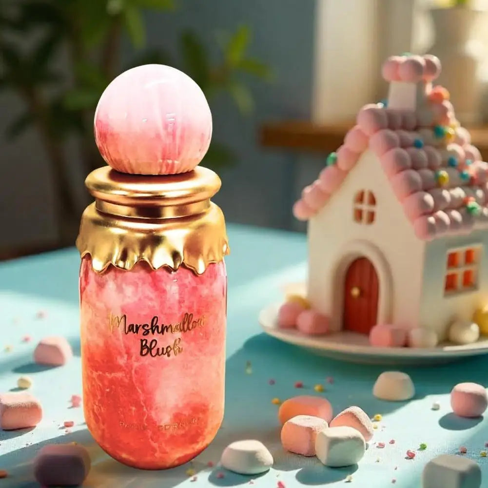Pink and gold bottle labeled 'Marshmallow Blush' with a marshmallow house in the background