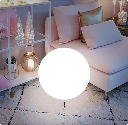 Living room with a white sofa, decorative pillows, and a shelf with small decorative items.