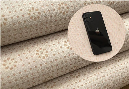 Phone on a roll of patterned back of rug