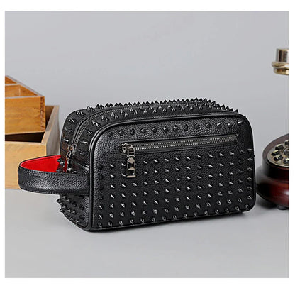 Black studded cosmetic bag with a red interior on a light gray background