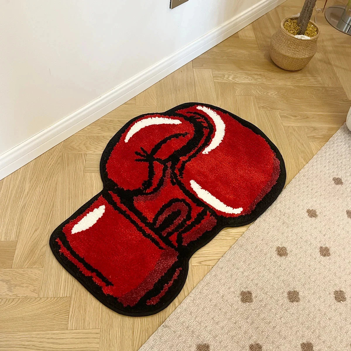 Red boxing glove rug on a wooden floor
