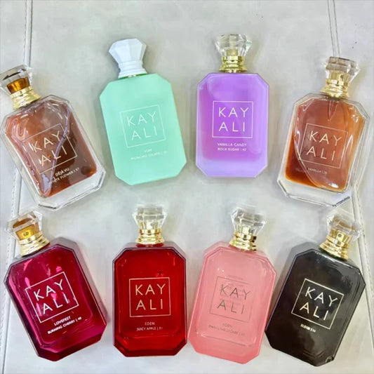 Collection of Kay Ali perfume bottles in various colors on a light background