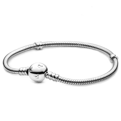 Silver bracelet with a round clasp on a white background