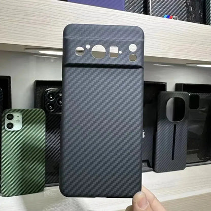Carbon fiber phone case held in front of a display of other phone cases.