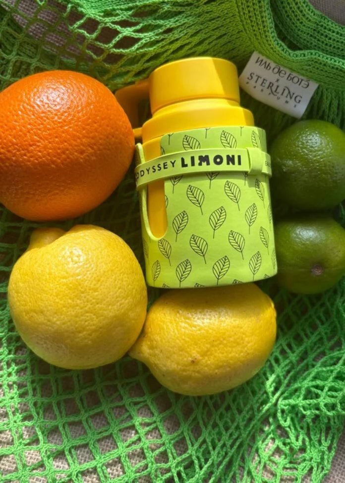 Yellow water bottle with 'Limonì' branding on a green mesh surface with fruits.
