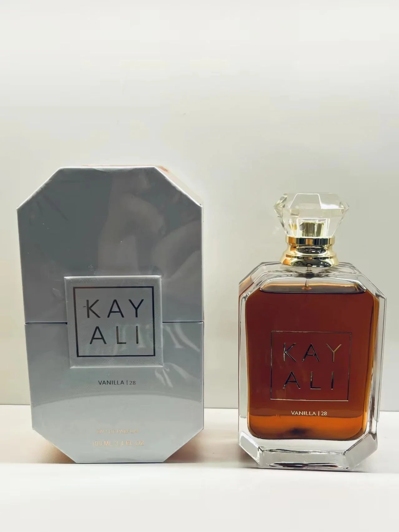 Perfume bottle and packaging of Kay Ali on a white background