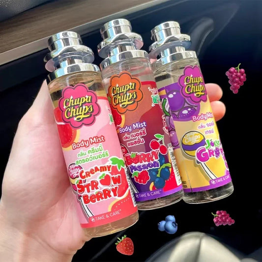 Four Chupa Chups body mist bottles held in a hand with colorful labels.