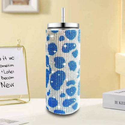 Decorative tumbler with blue floral pattern on a white surface