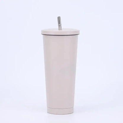 Beige tumbler with a straw on a white background