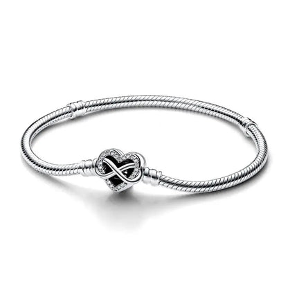 Silver bracelet with a heart-shaped clasp on a white background