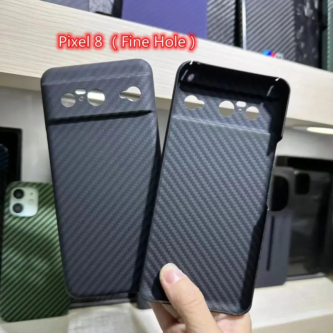 Two phone cases with 'Pixel 8 (Fine Hole)' text held by a hand against a blurred background.