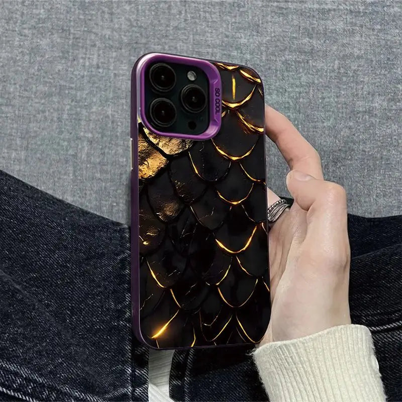 Phone case with gold dragon scale design held by a person against a gray background
