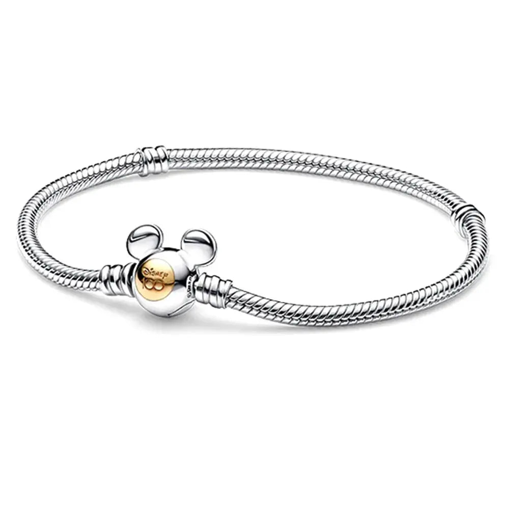 Disney Mickey Mouse silver bracelet with a gold charm on a white background