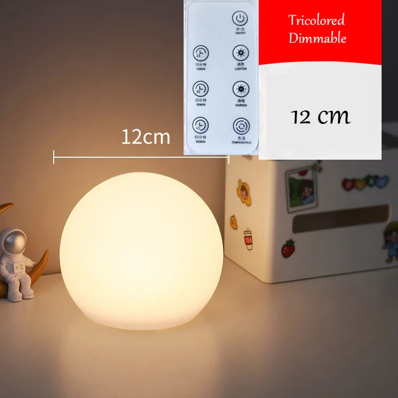 Small round lamp with a remote control labeled 'Tricolored Dimmable' on a surface.