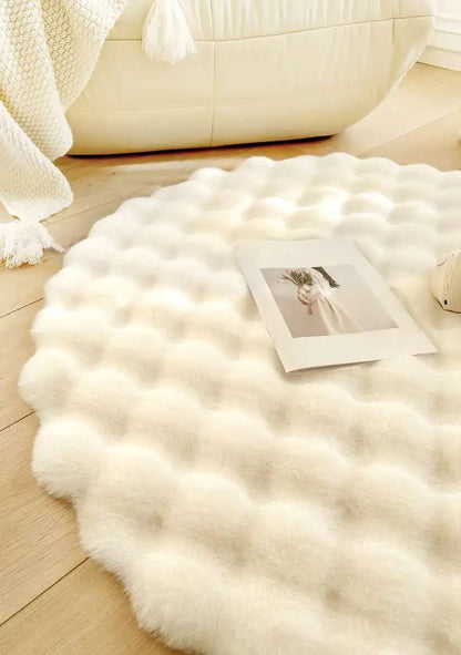 White fluffy rug on a wooden floor with a photo on top