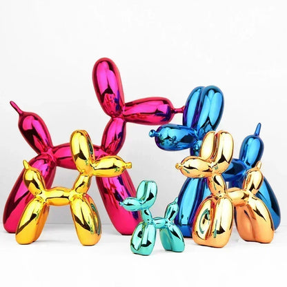 Colorful balloon dog sculptures in gold, pink, blue, and turquoise on a white background