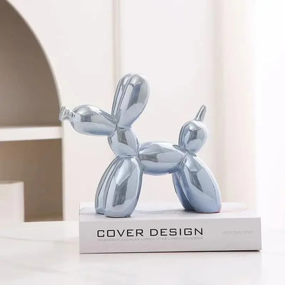 Silver balloon dog sculpture on a book with 'Cover Design' branding.