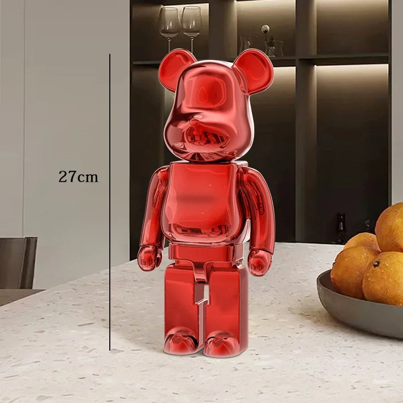 Red transparent bear-like figure on a table with a bowl of oranges in the background be@rbrick collectable