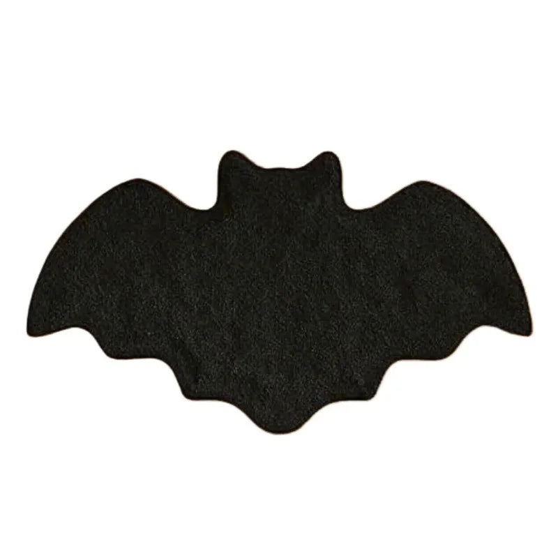 Black bat-shaped object on a white background