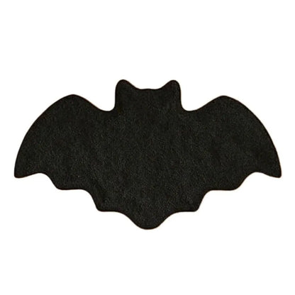 Black bat-shaped object on a white background