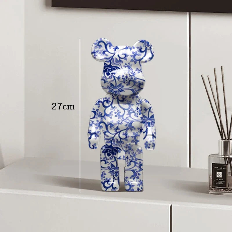 Blue and white floral patterned bear-shaped object on a white surface with measurement label be@rbrick collectable