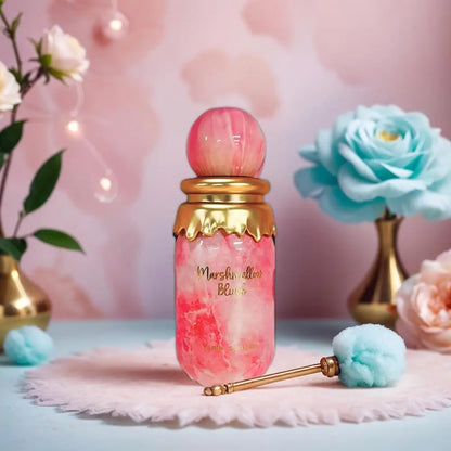 Pink and gold perfume bottle with decorative elements on a soft pink background