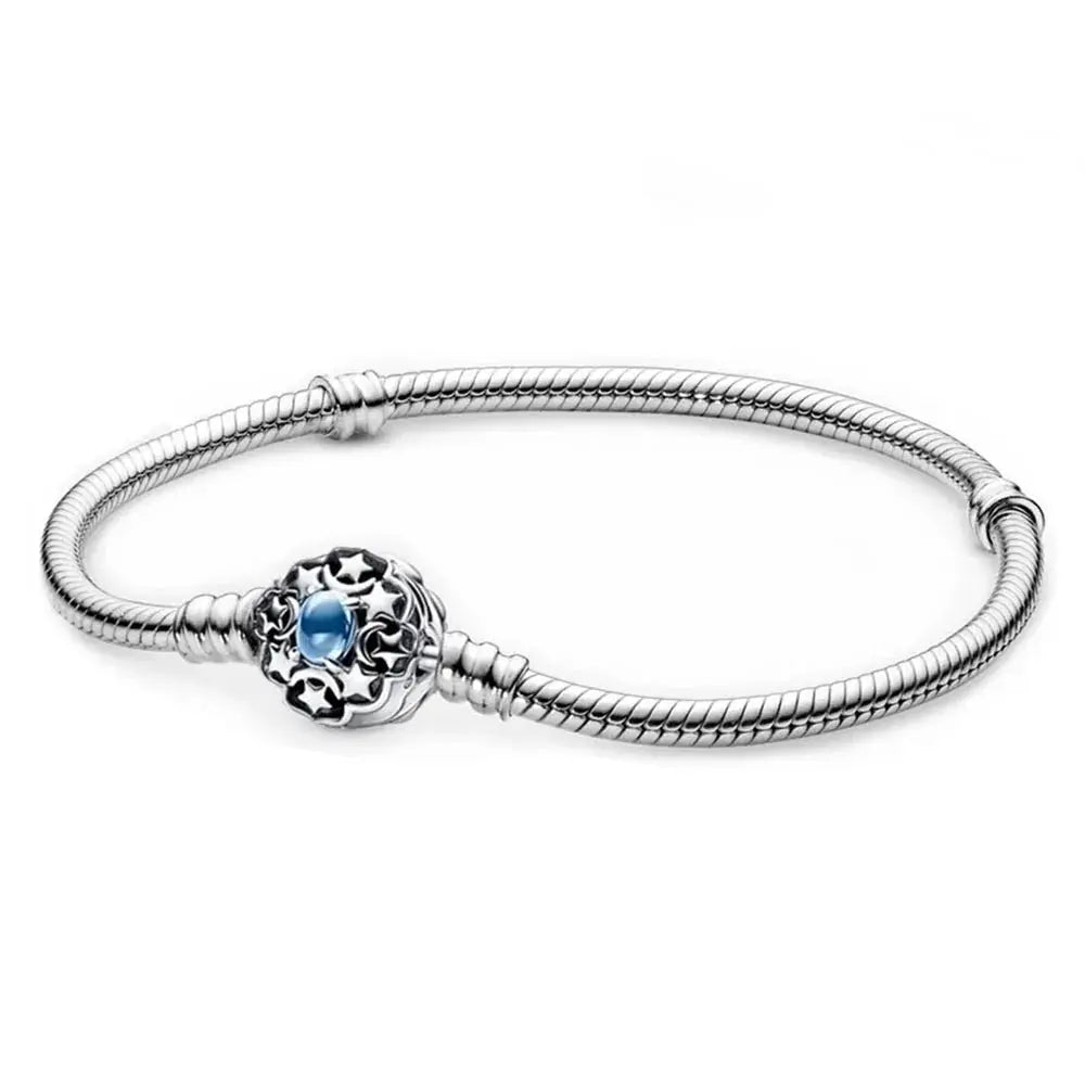 Silver bracelet with a blue gemstone charm on a white background