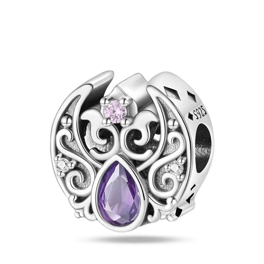 Silver charm with purple teardrop-shaped gem and pink gem on a white background