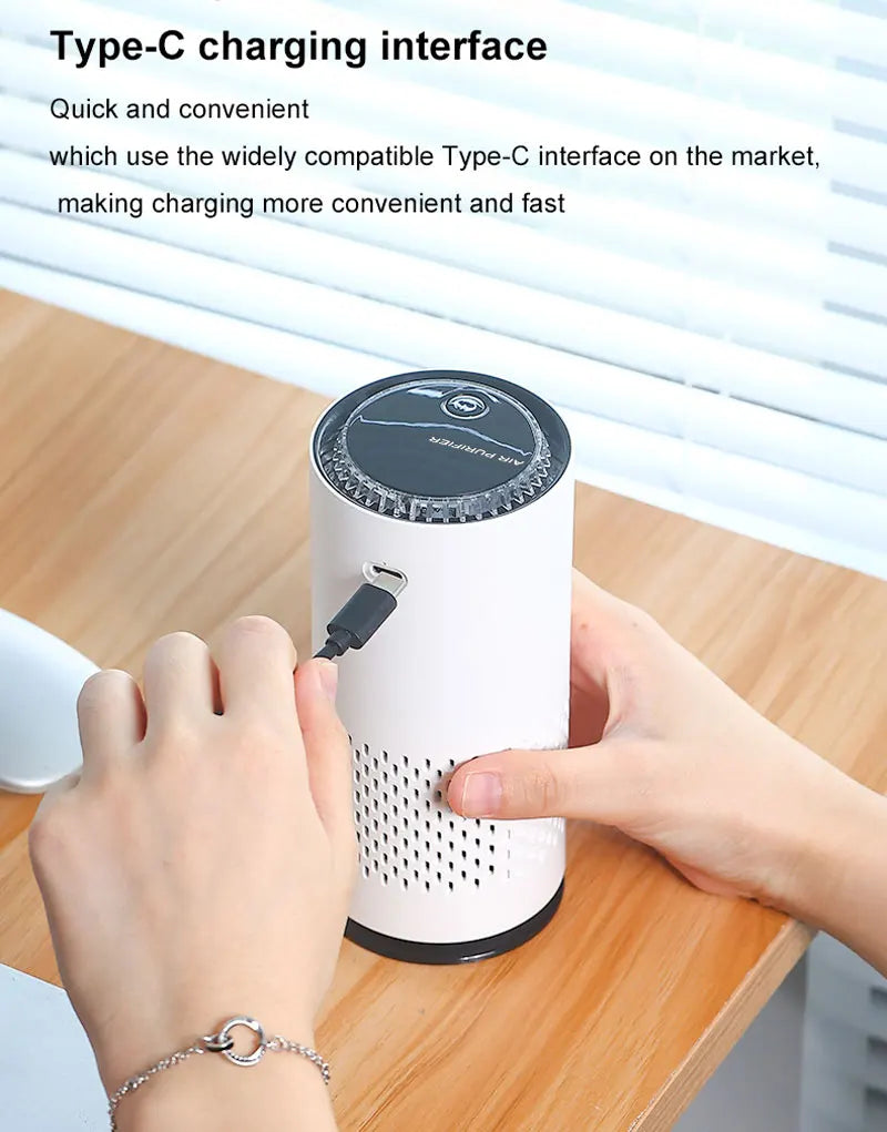 White cylindrical device with black top being plugged into a Type-C port on a wooden surface.