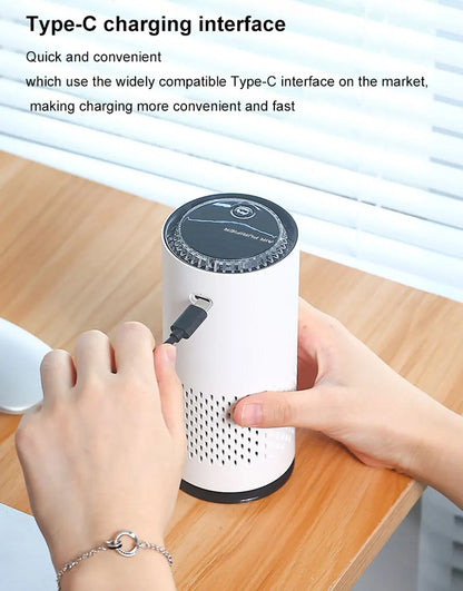 White cylindrical device with black top being plugged into a Type-C port on a wooden surface.
