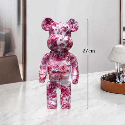 Pink and white marbled bear-shaped figure on a table with a measurement label be@rbrick collectable