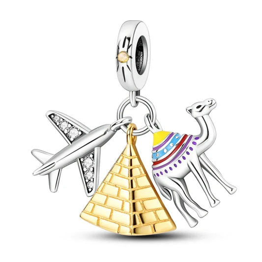 Jewelry charm with airplane, pyramid, and camel on a white background