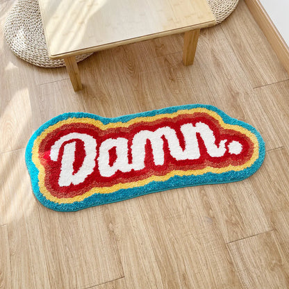 Colorful rug with 'Damu' text on a wooden floor