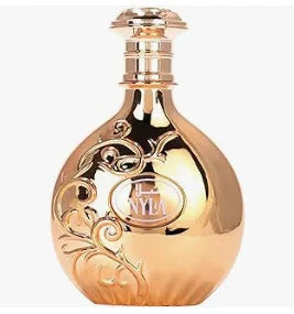 Gold perfume bottle with intricate designs on a white background