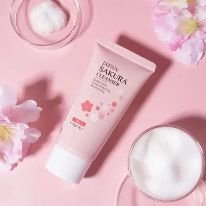 Japan Sakura cleanser tube on a pink background with flowers and foam.