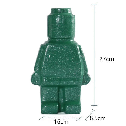 Two Lego Man Vases, one black and one white, designed to look like figures with a decorative plant in each.