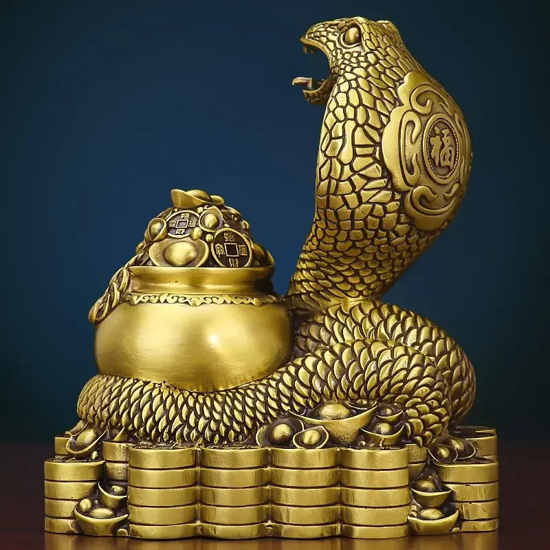 A bronze colored metal ornament in the shape of a snake coiled around a pot with Chinese characters inscribed, representing the Twelve Zodiac Snakes theme.