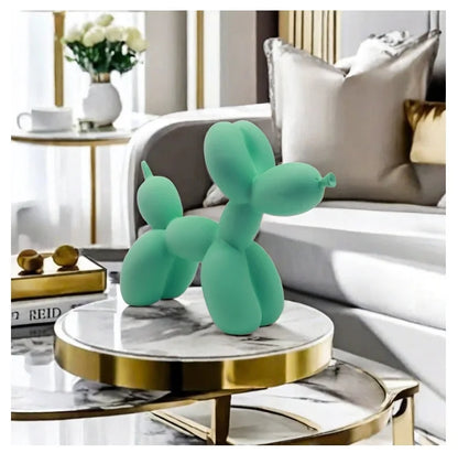 Turquoise balloon dog sculpture on a marble table in a stylish living room.