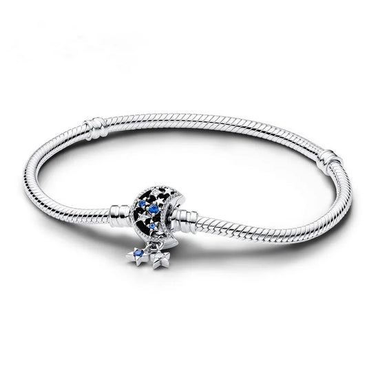 Moon and stars Silver bracelet with a decorative charm on a white background