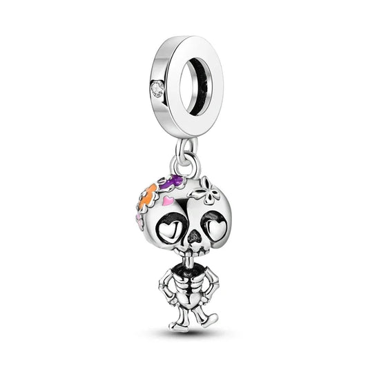 Silver skeleton charm with colorful accents on a white background
