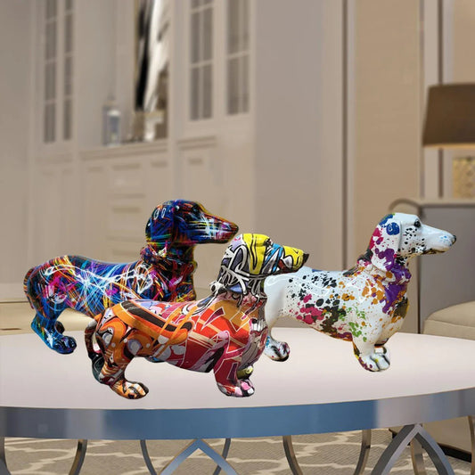 Three colorful dachshund figurines on a table with a blurred indoor background dashhound 