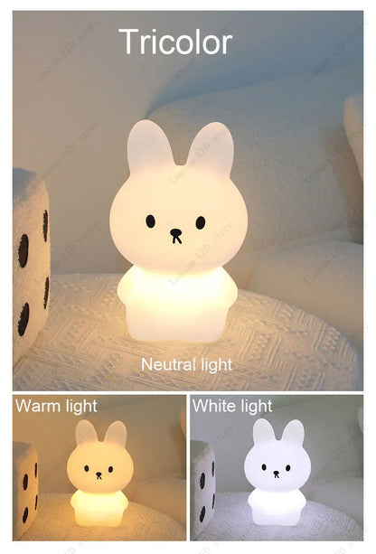 Tricolor rabbit-shaped night light on a soft surface with text indicating neutral, warm, and white lights.