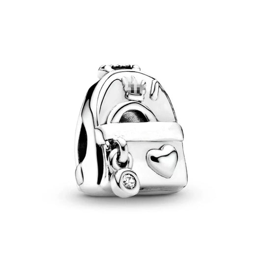 Silver charm with a heart and small round element on a white background
