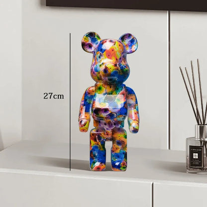 Colorful bear-shaped figure on a white surface with a measurement label, next to a diffuser. be@rbrick collectable