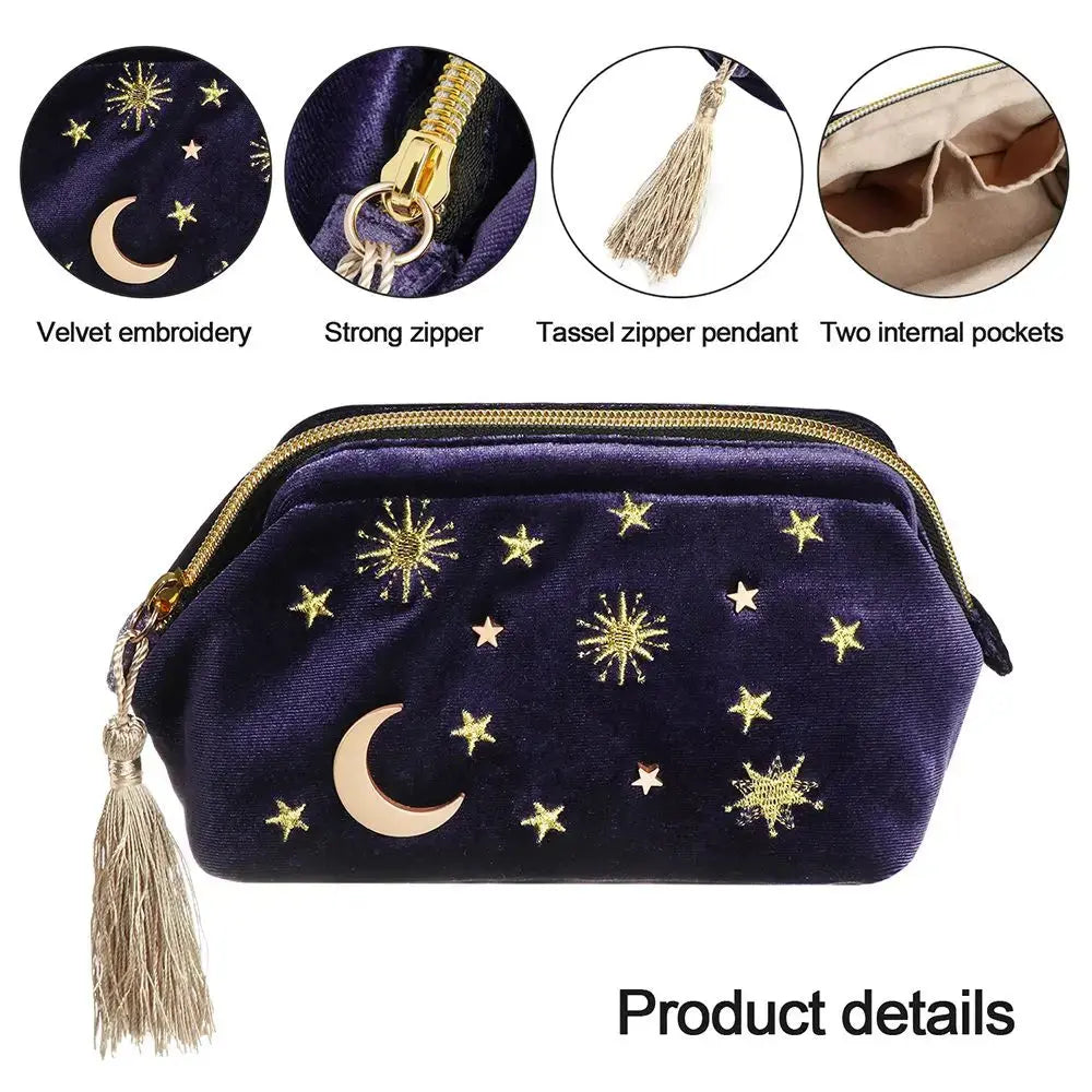Navy blue pouch with gold star and moon embroidery, tassel, and zipper details on a white background.