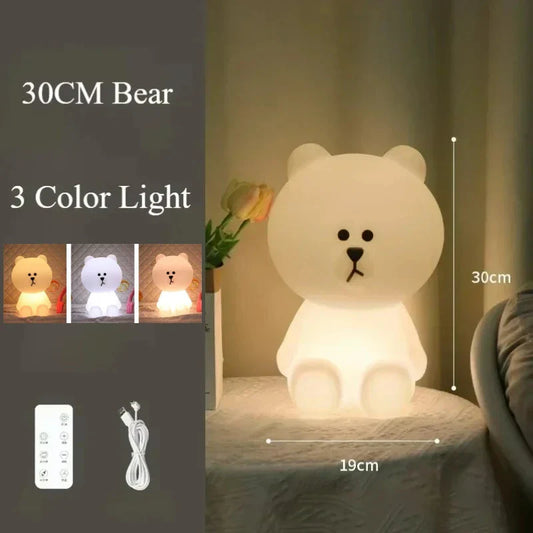 White bear-shaped night light with 3 color options on a table.