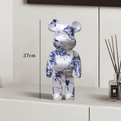 White bear figurine with blue floral patterns on a white surface, next to a diffuser. be@rbrick collectable